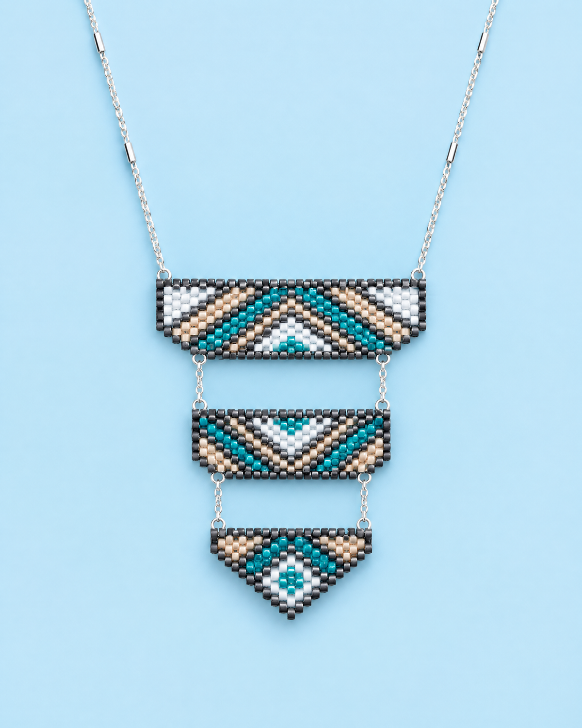 Teal Tiered Pendant on blue background