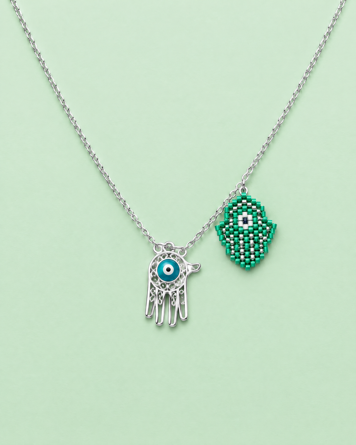 Green Hamsa Charm Necklace on mint background