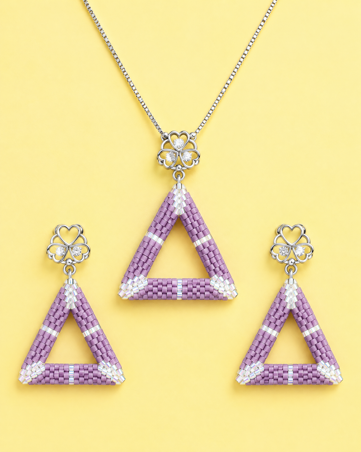 Lilac Triangle Pendant with matching earrings on yellow background