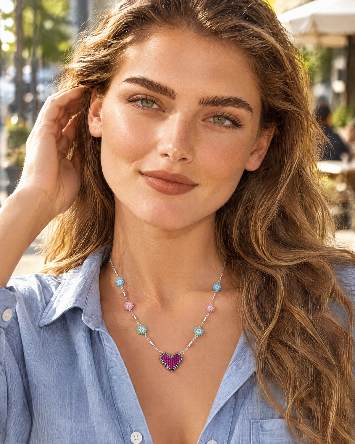 Model wearing the Daisy Heart Charm Necklace with a chambray shirt