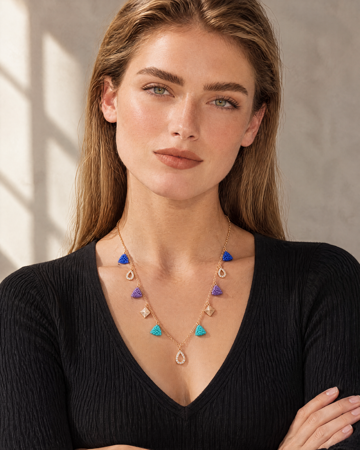 Model wearing the Jewel Triangle Charm Necklace with a black V-neck top